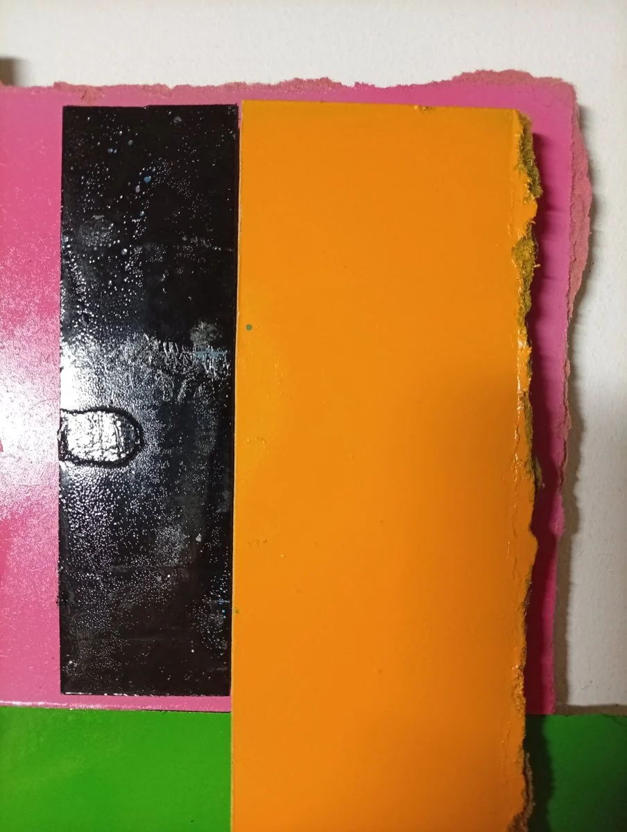 A colorful abstract composition of layered rectangular blocks with torn edges.