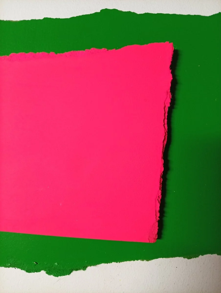 A layered composition of torn paper shapes in vivid pink and green against a white background.