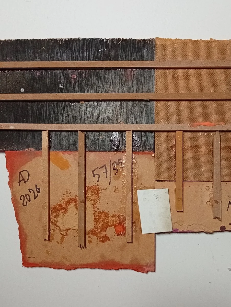 A colorful abstract composition of layered, torn rectangular shapes in primary and secondary colors.