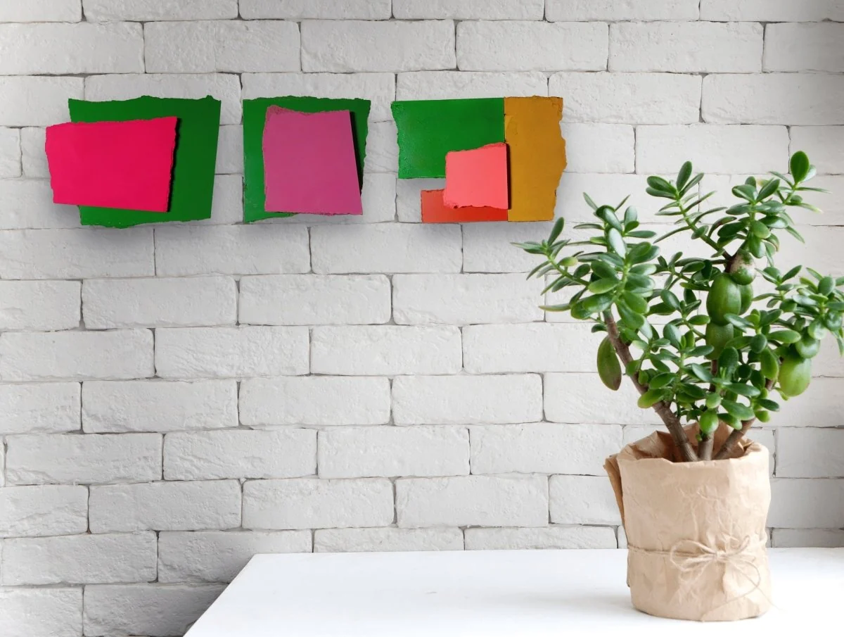 A colorful abstract composition of four painted paper fragments arranged in a grid.