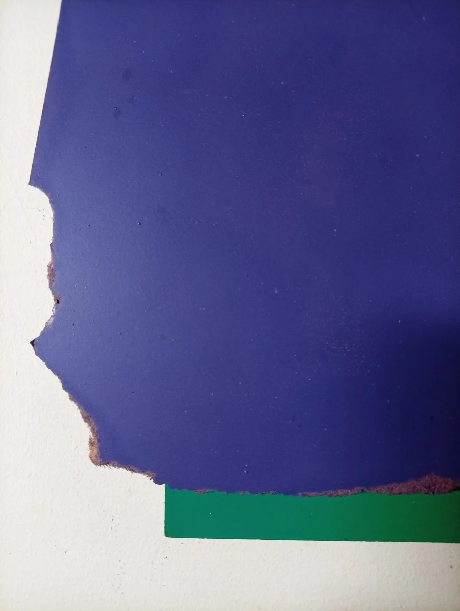A layered composition of torn paper pieces in deep blue and forest green.