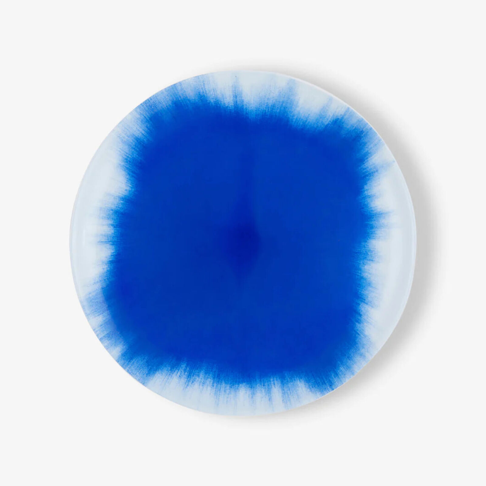 A blue and white plate with a circular design on it.
