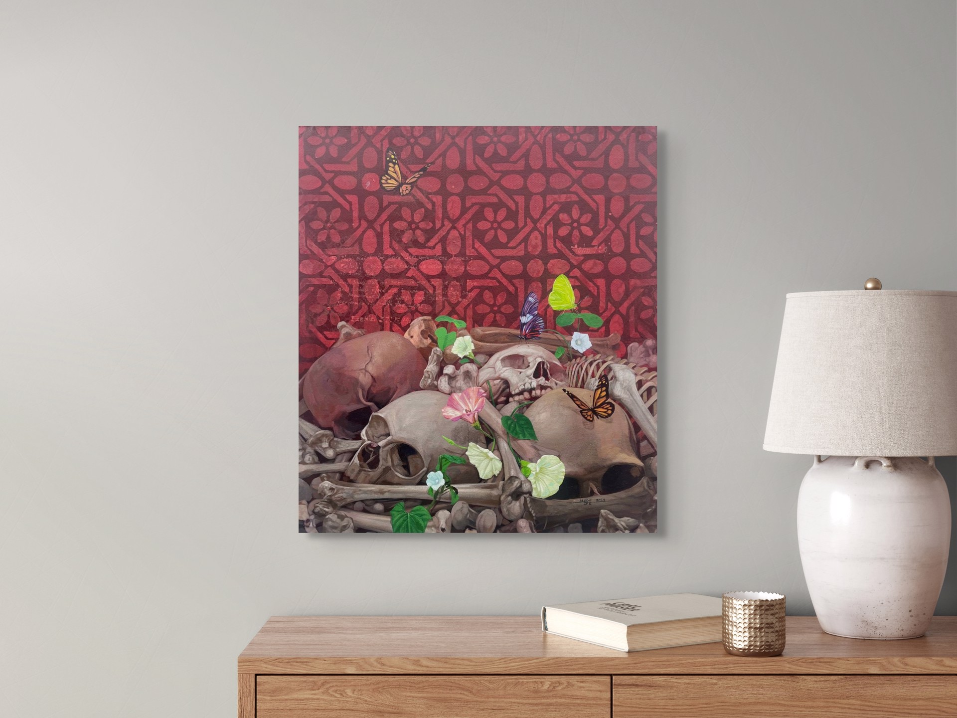 A painting of skulls and flowers with butterflies on them.