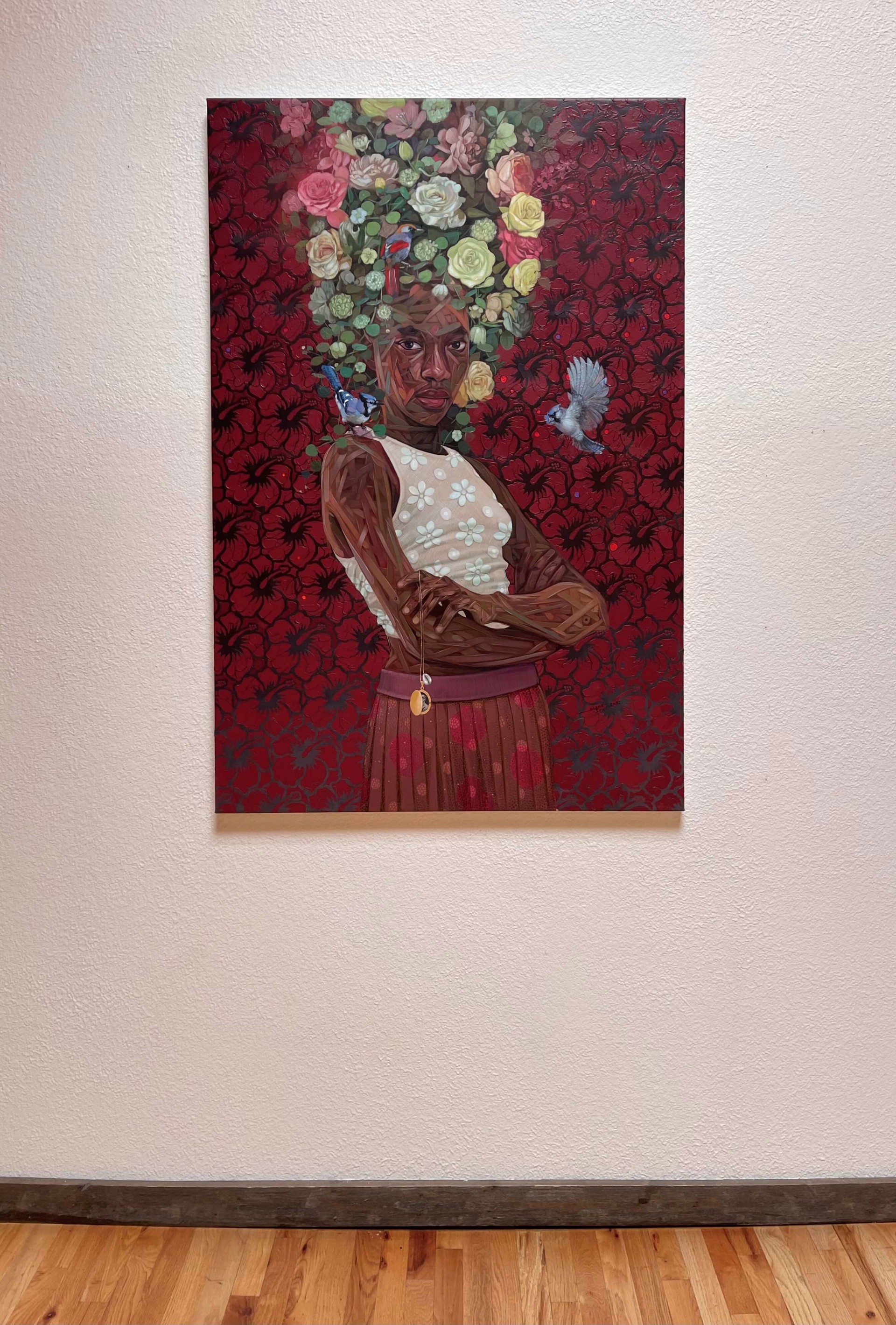 A portrait of a figure with a floral crown and birds, set against a red patterned background.
