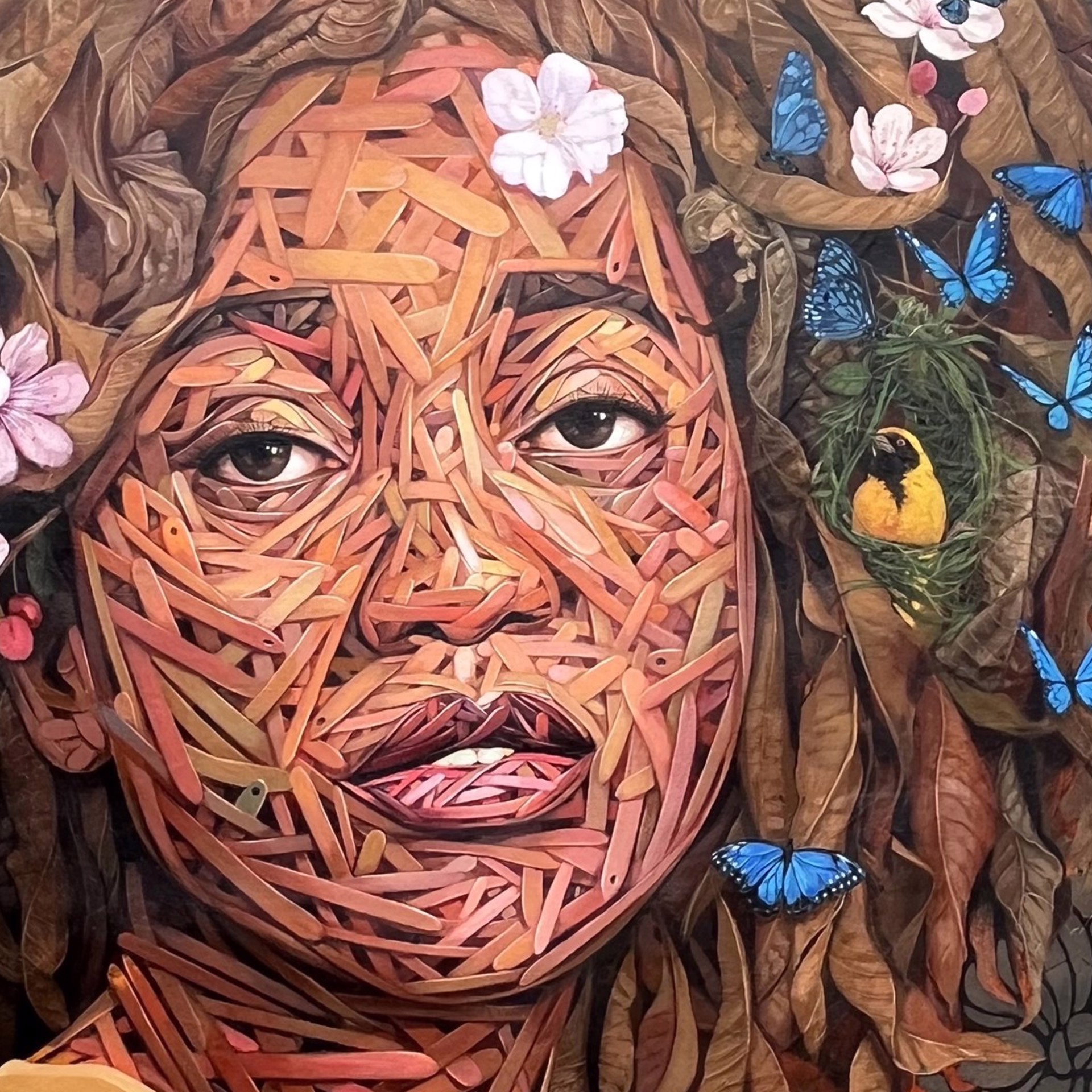 A painting of a woman with flowers and butterflies on her head.
