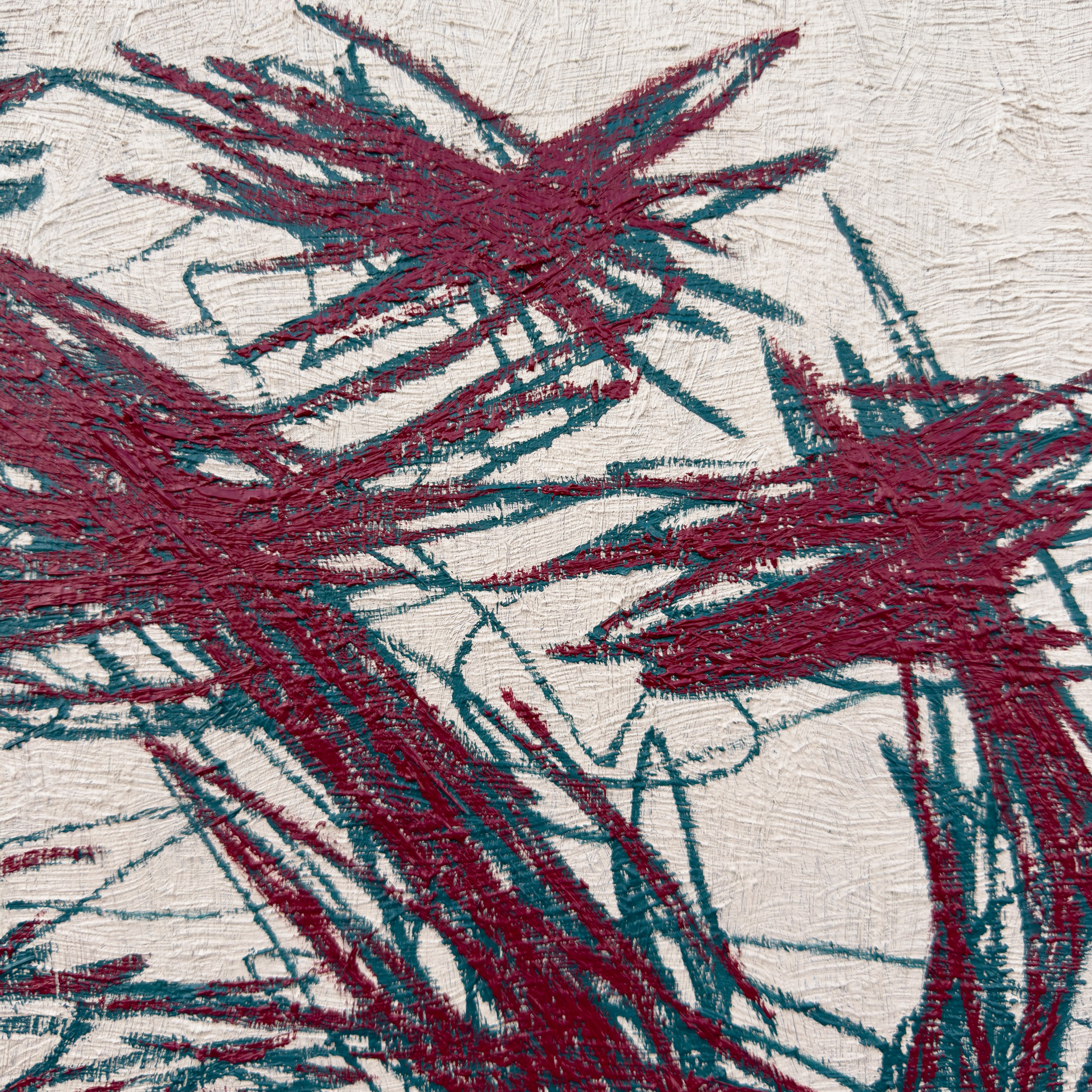 A close-up of a textured surface featuring bold, abstract brushstrokes in deep red and teal.
