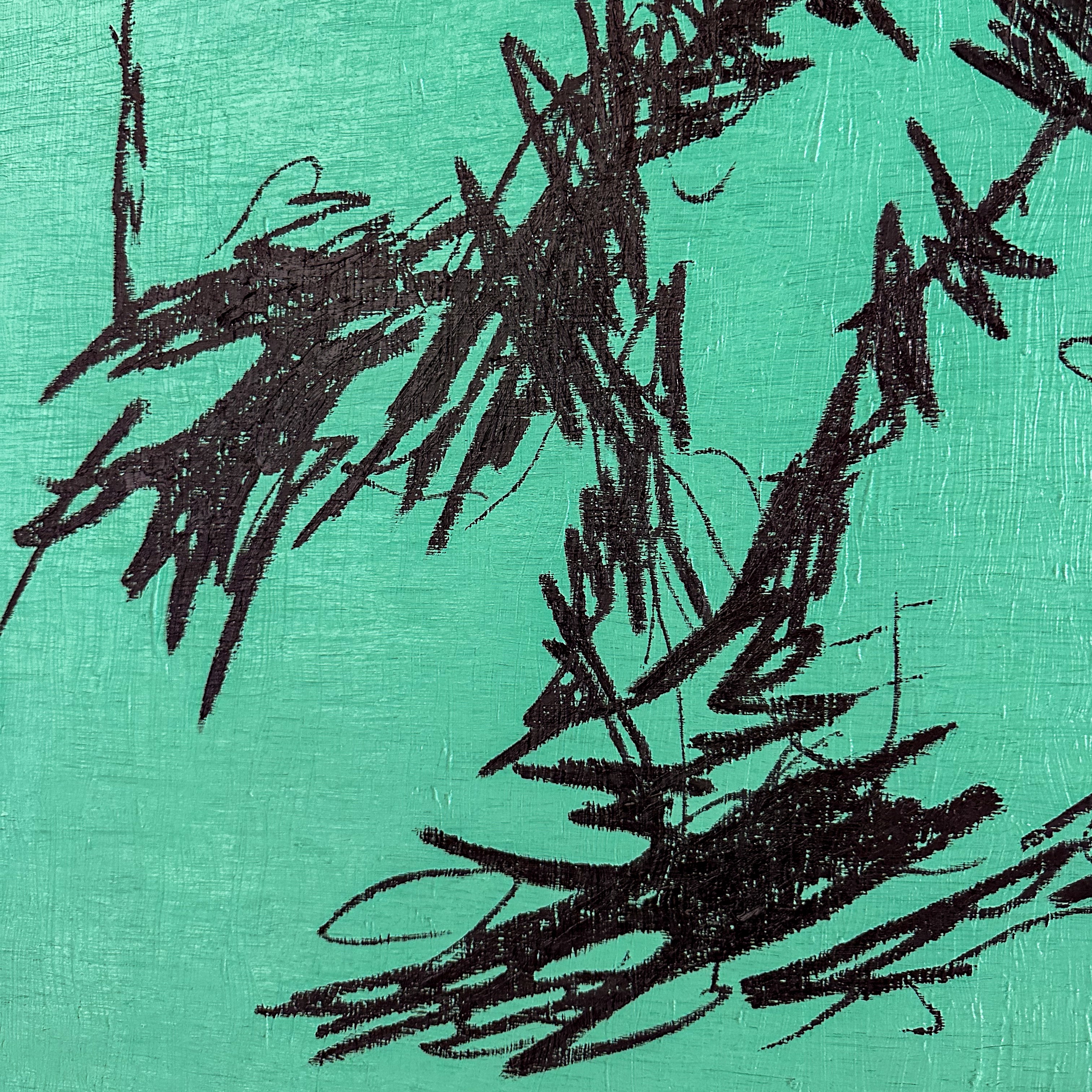 A close up of a painting with black paint on a green background.