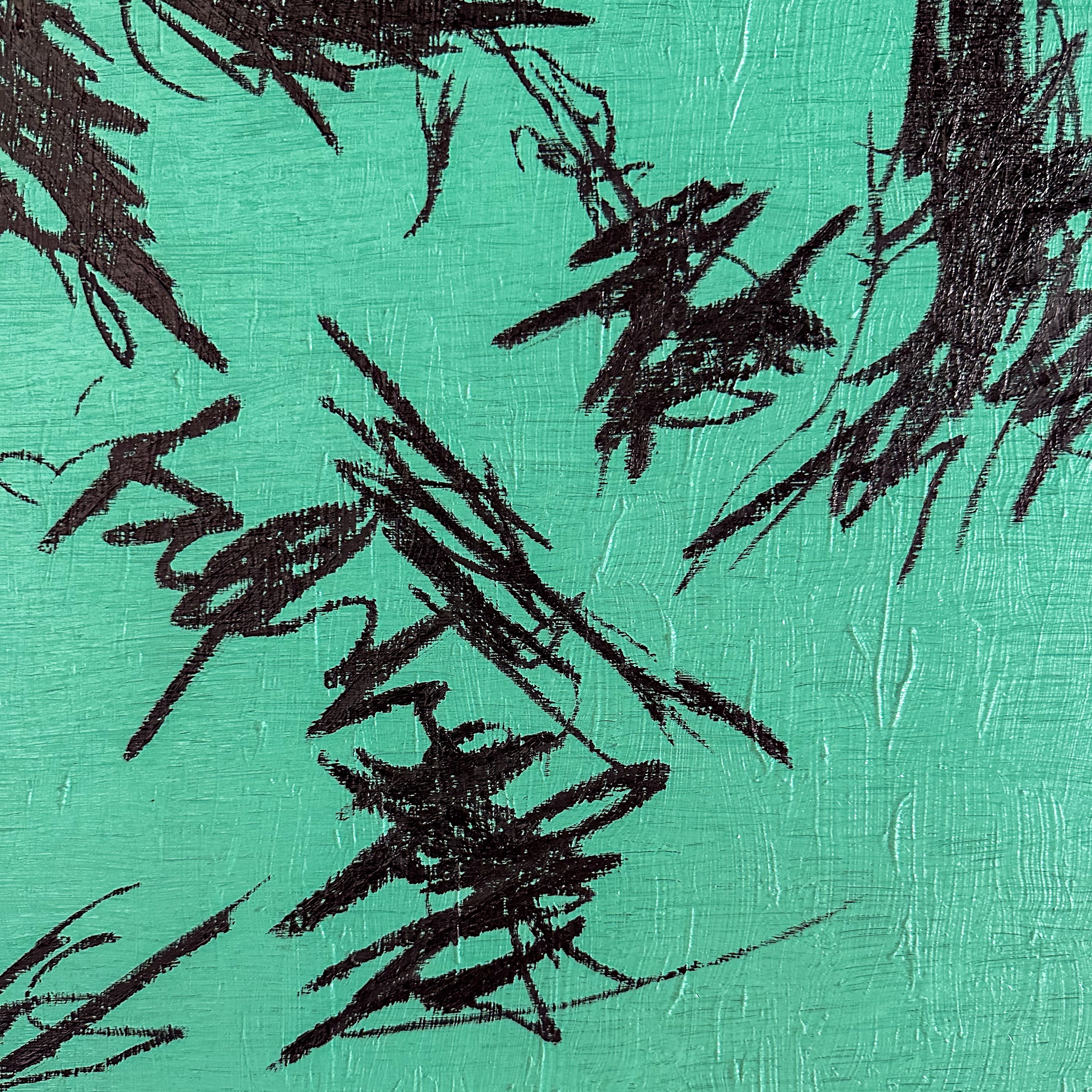 A close up of a painting with black paint on a green background.