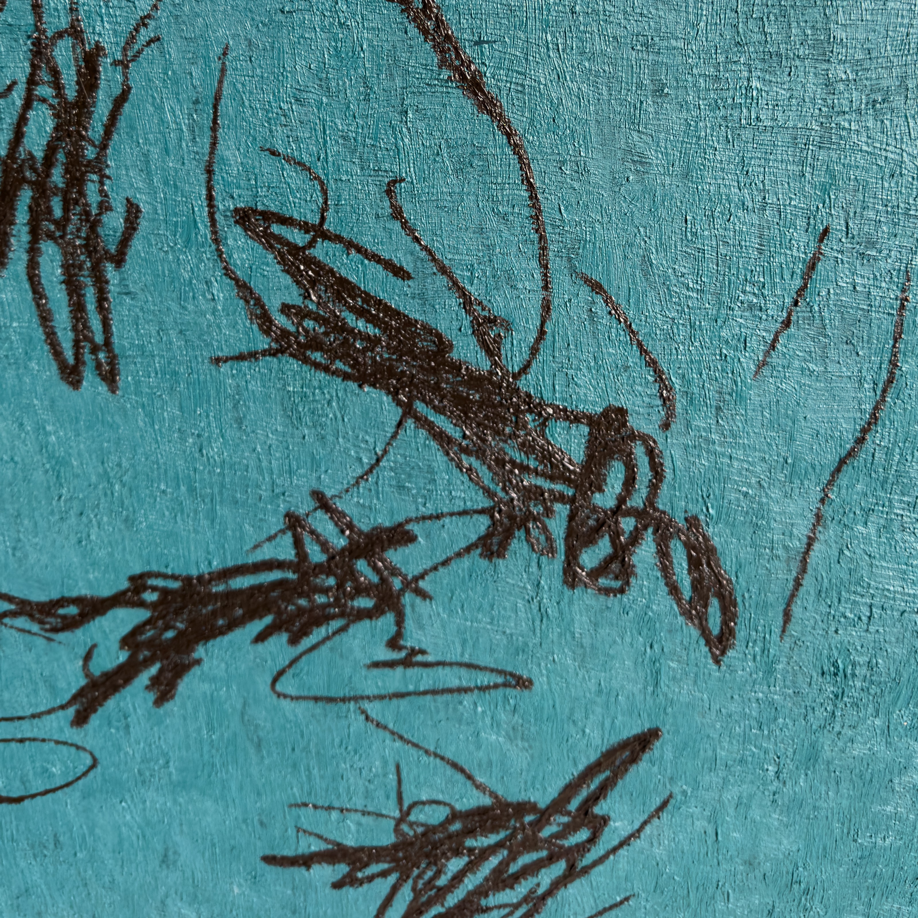 A close up of a blue wall with a drawing on it.