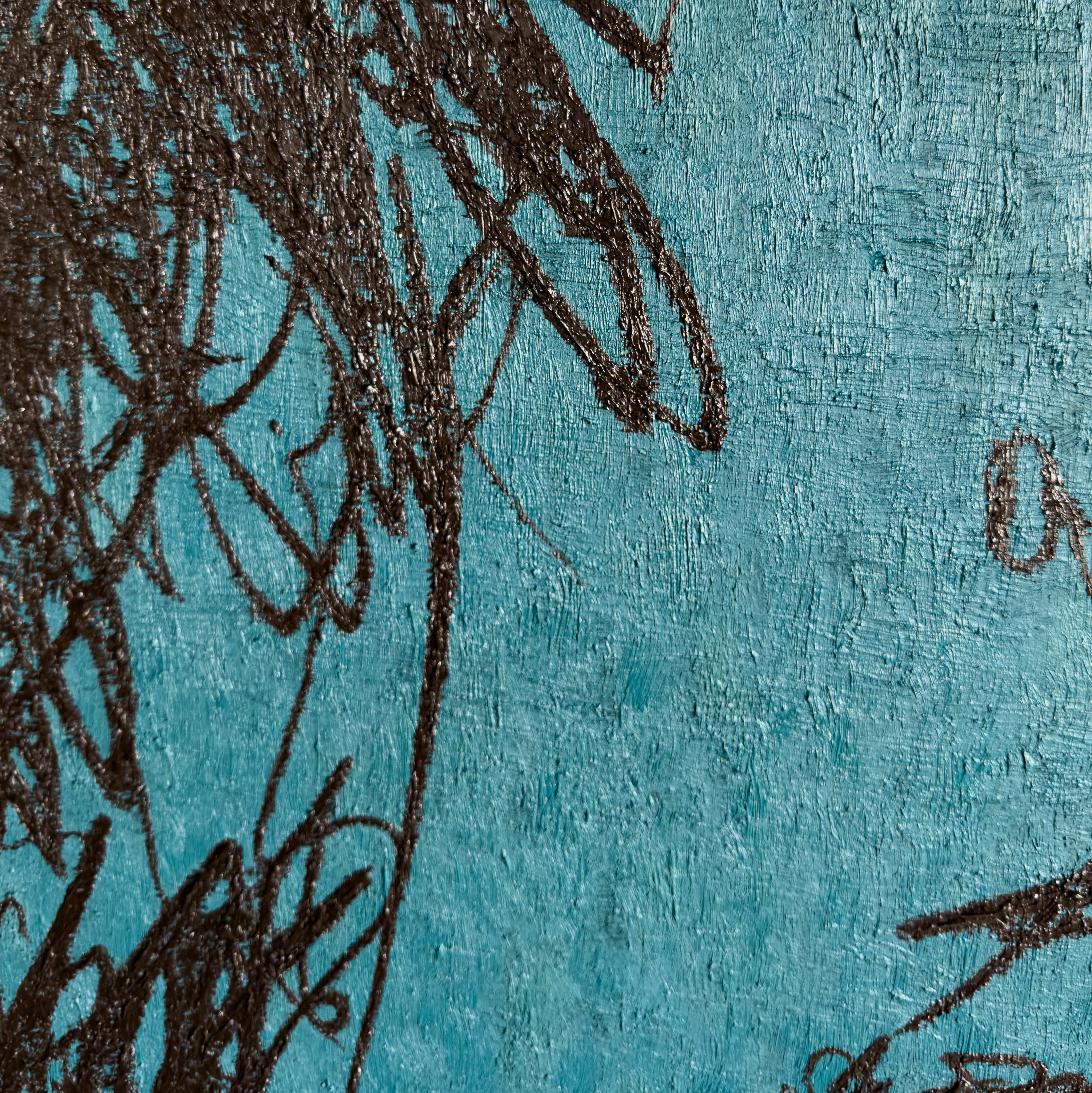 A close up of a blue wall with a drawing on it.