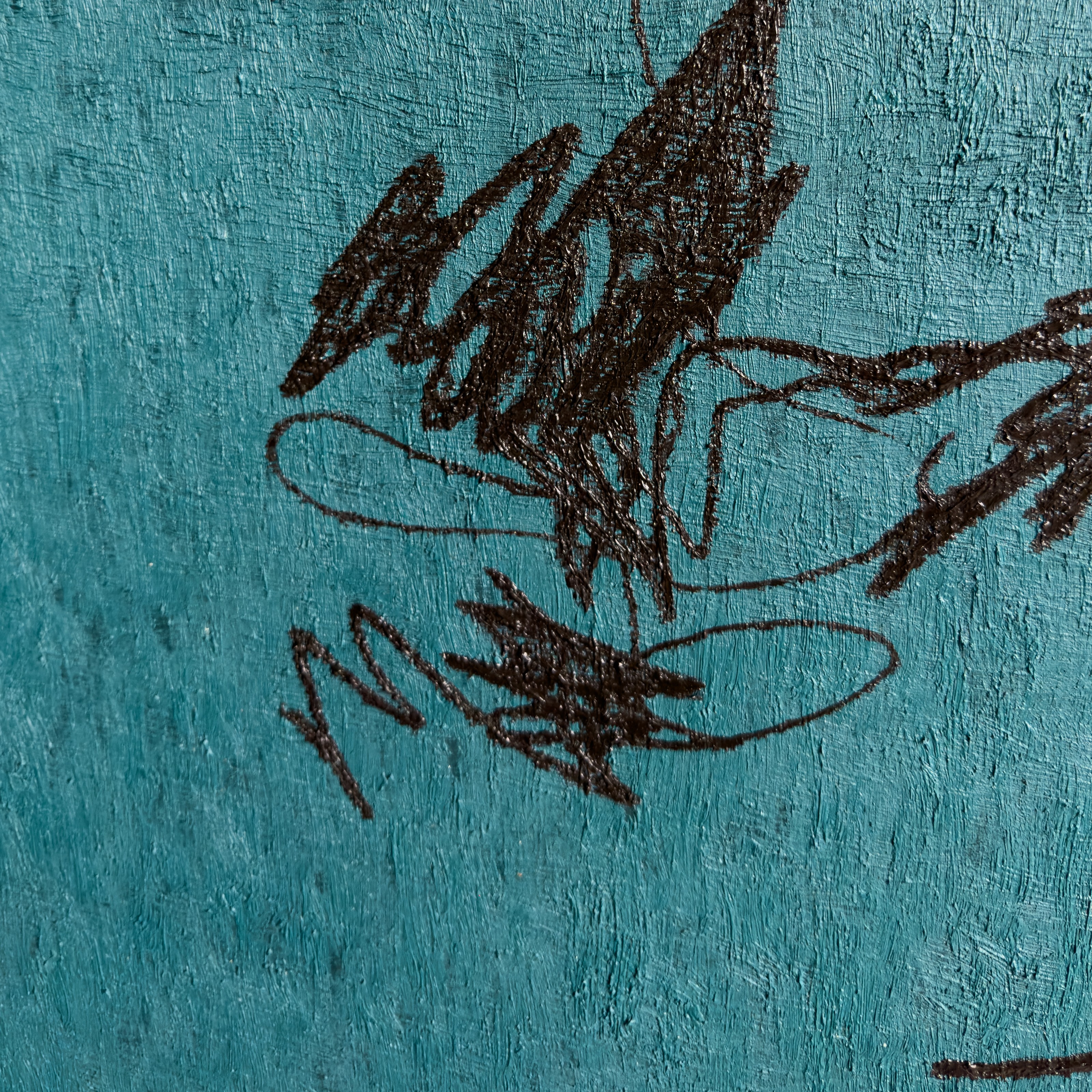 A close up of a blue wall with a drawing on it.