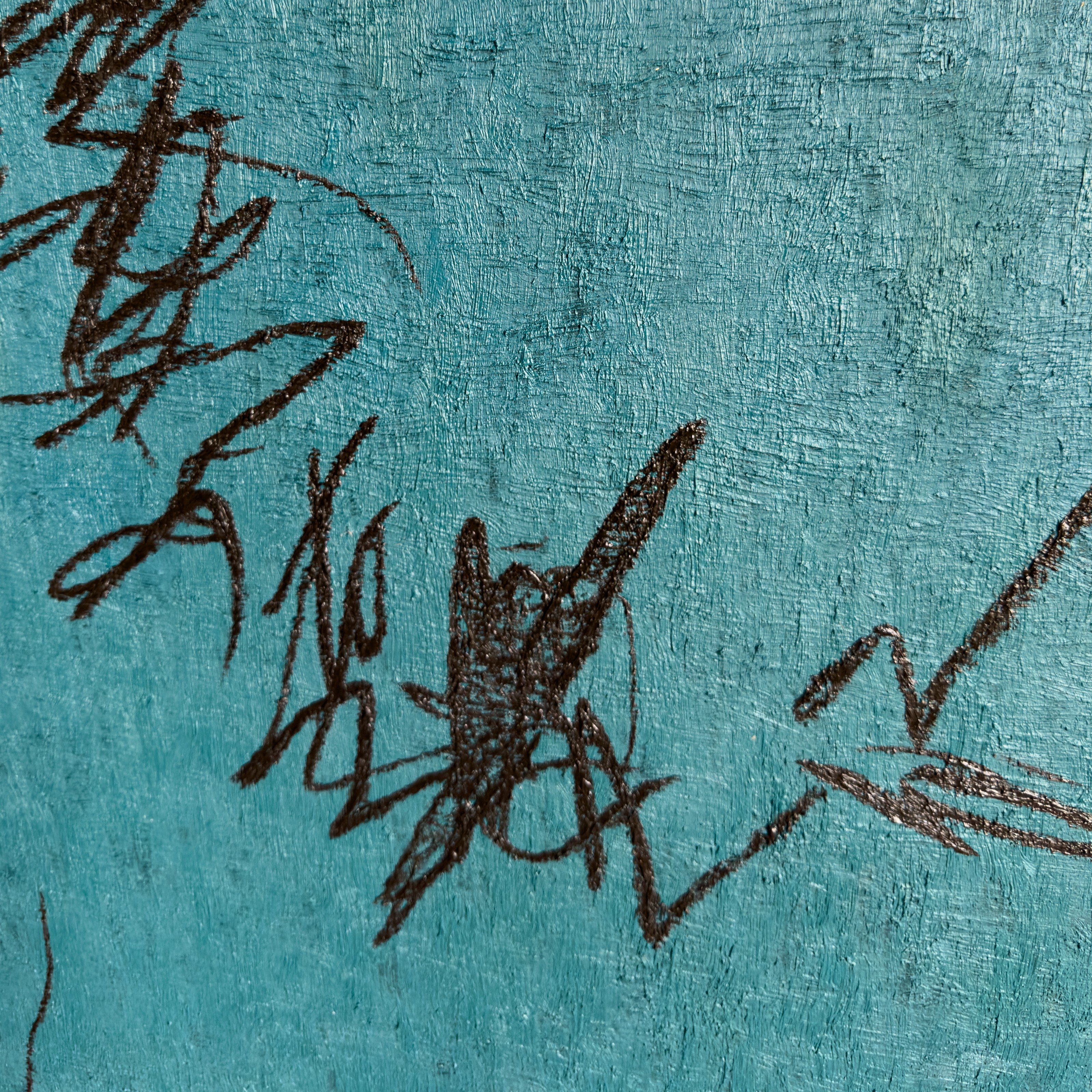A close up of a blue wall with a drawing on it.
