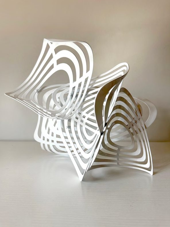 A white, multi-layered sculpture with concentric curved forms