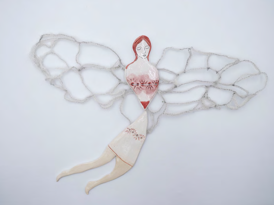 A ceramic figure with delicate wings and floral details.