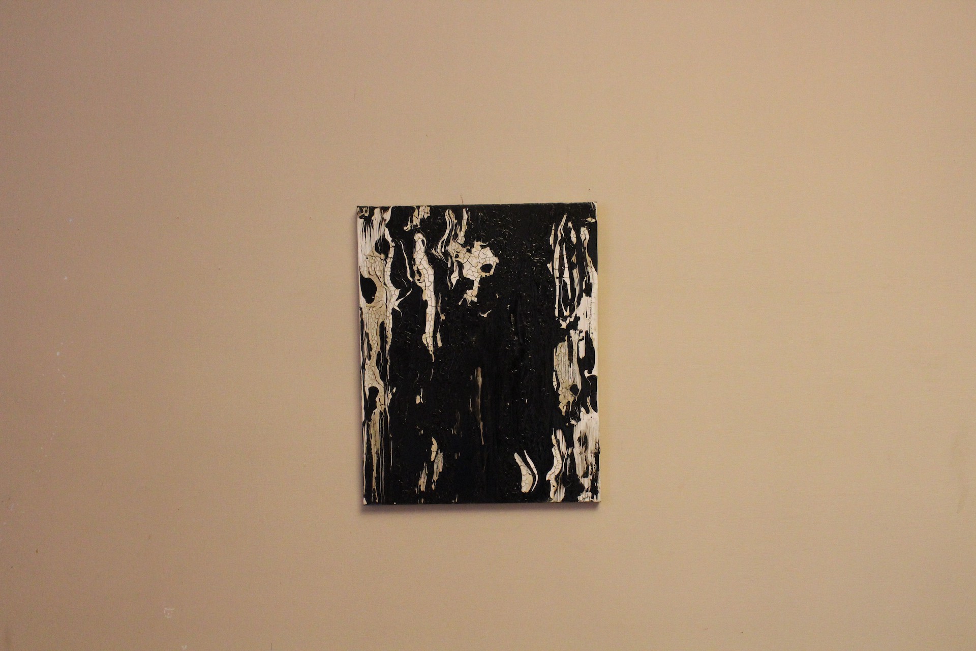 A dramatic abstract composition featuring glossy black and textured white forms.