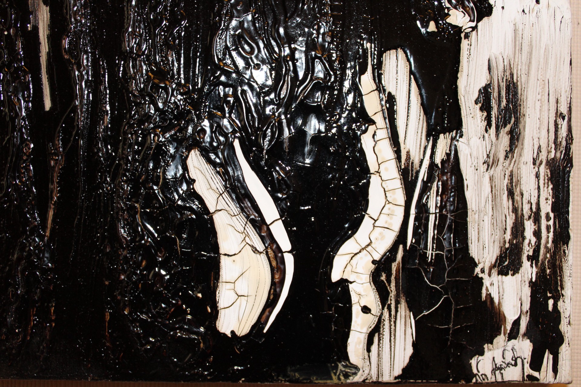 A dramatic abstract composition featuring glossy black and textured white forms.