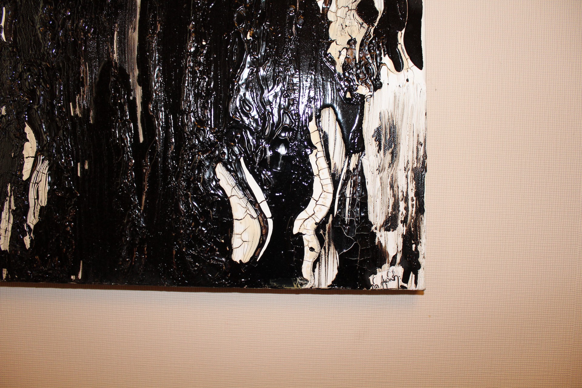 A dramatic abstract composition featuring glossy black and textured white forms.