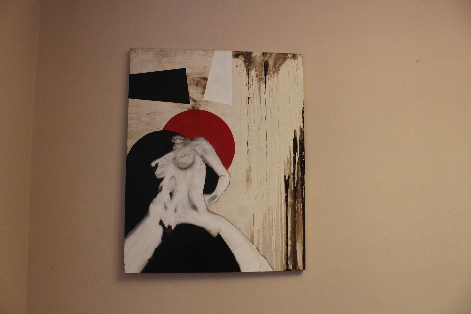 A painting hanging on a wall in a room.