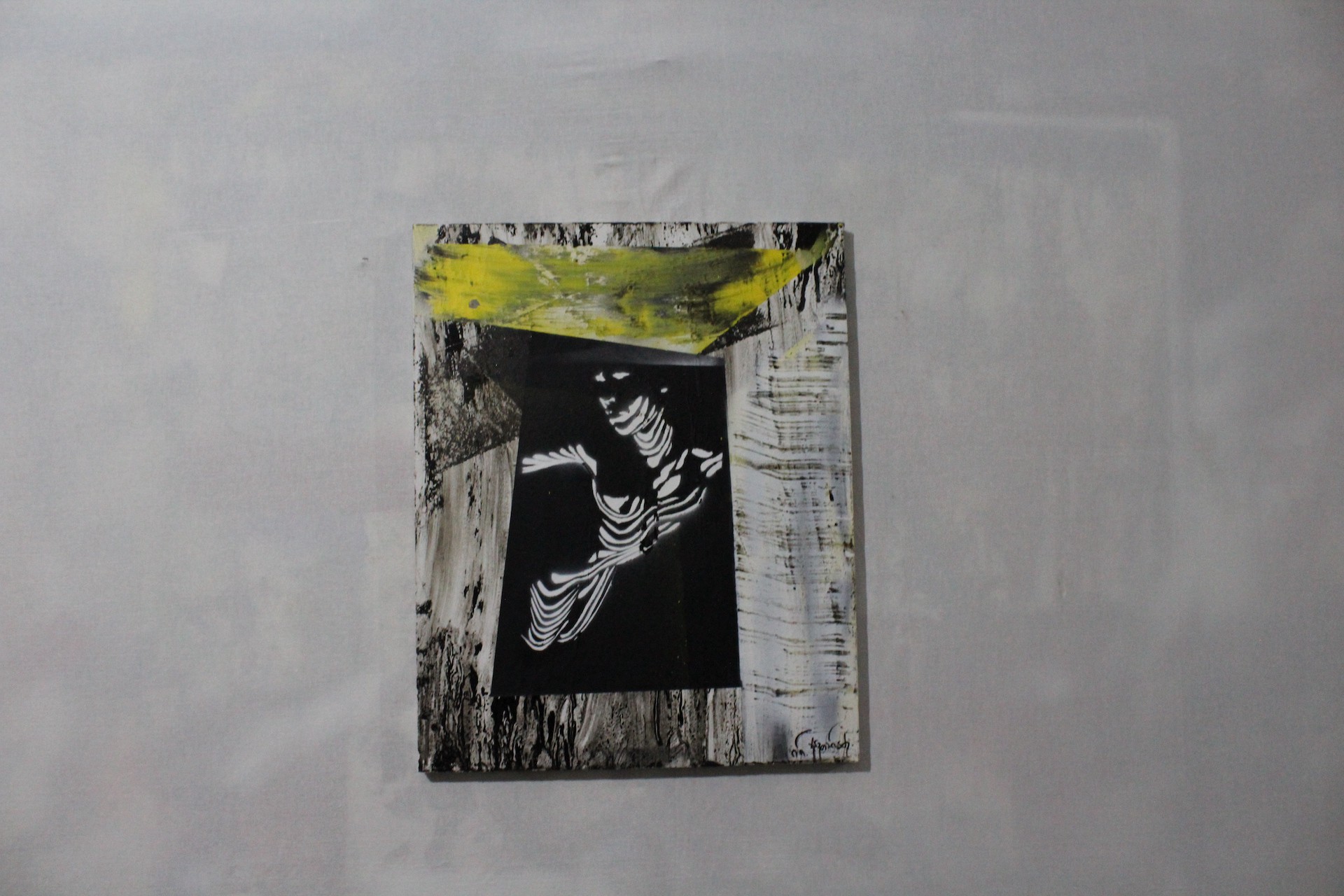 A black and white painting on a white wall.