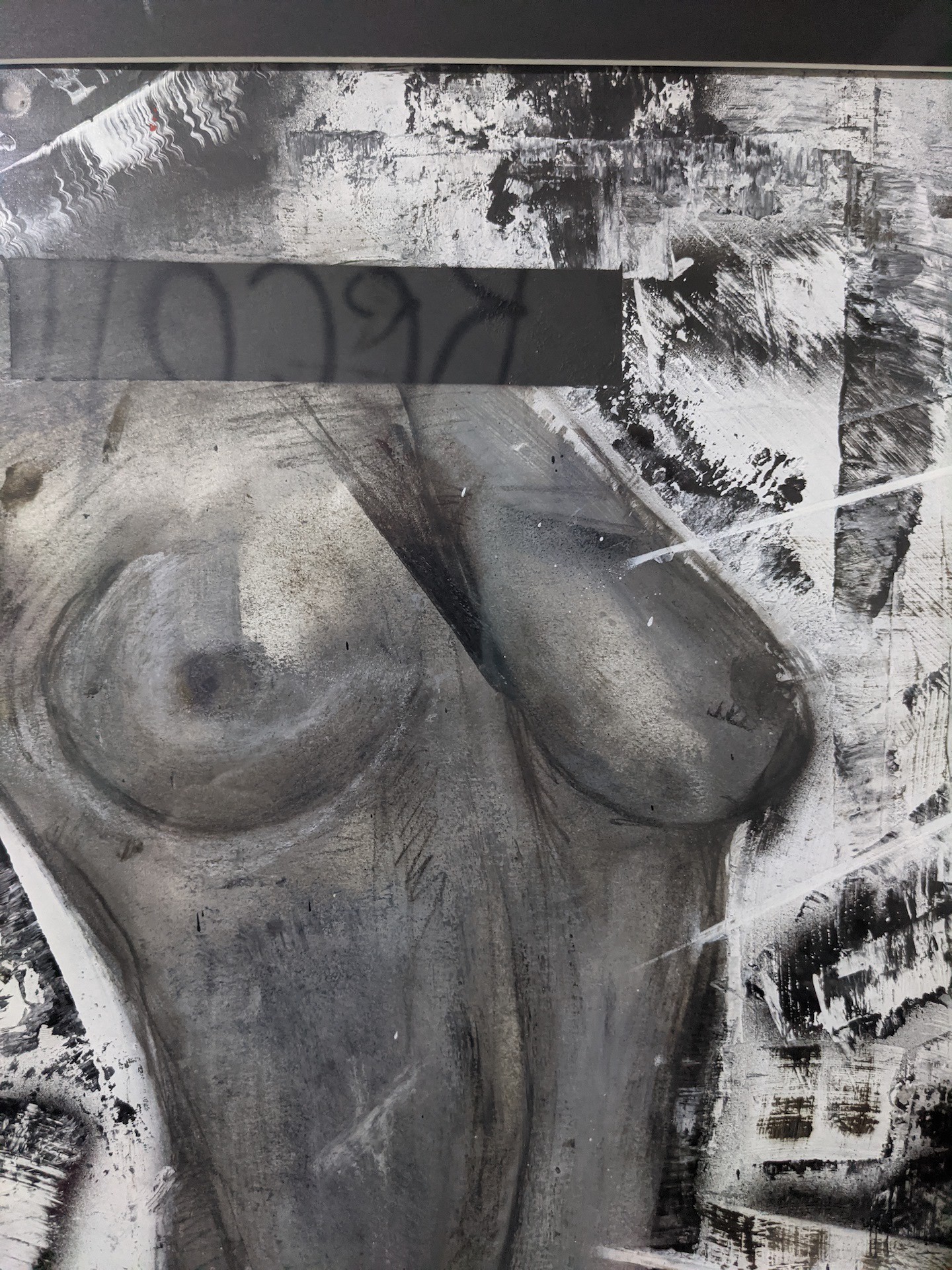 A black and white painting hanging on a wall.