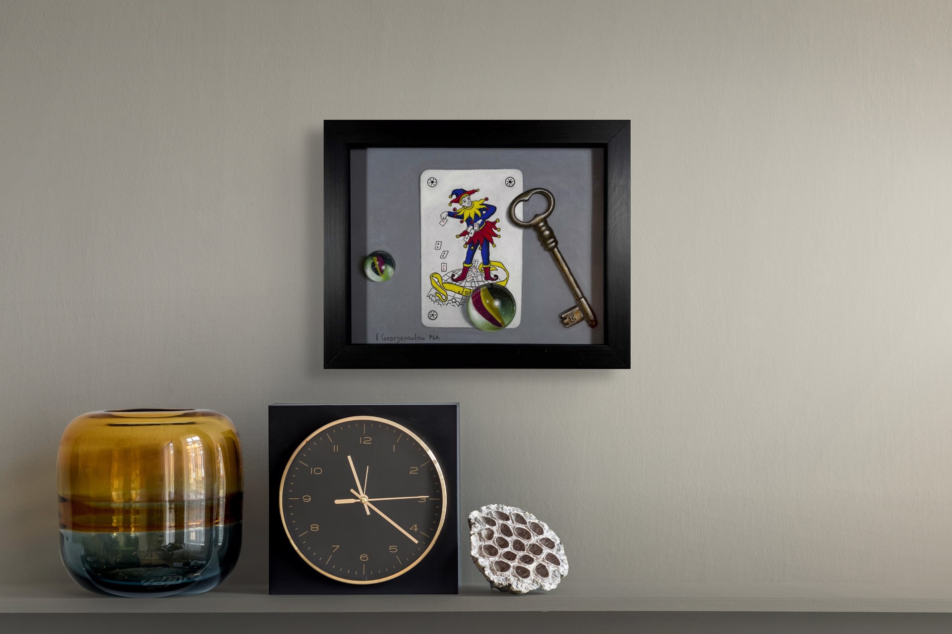 A drawing of a joker playing card next to a key and a glass ball.