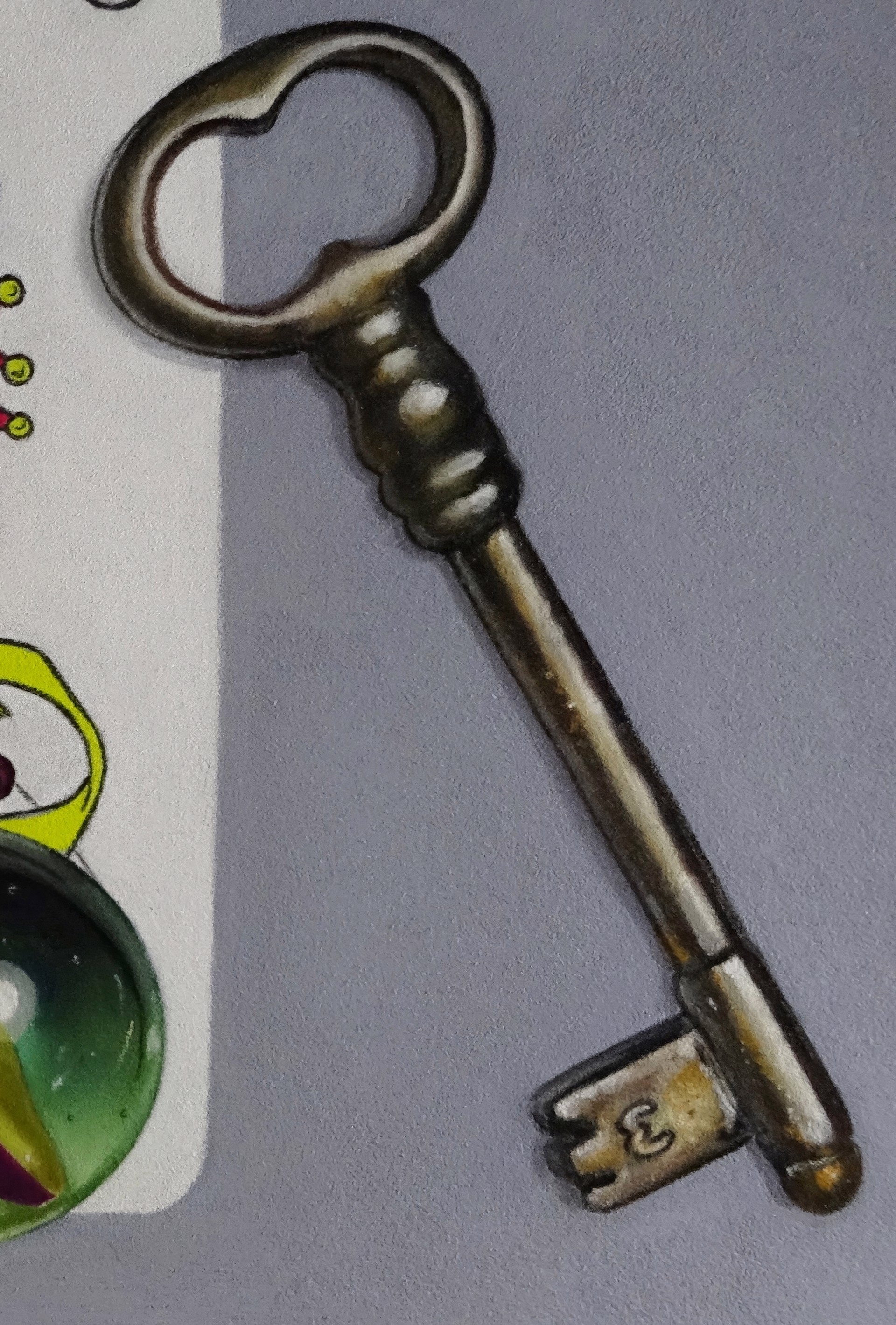 A drawing of a joker playing card next to a key and a glass ball.
