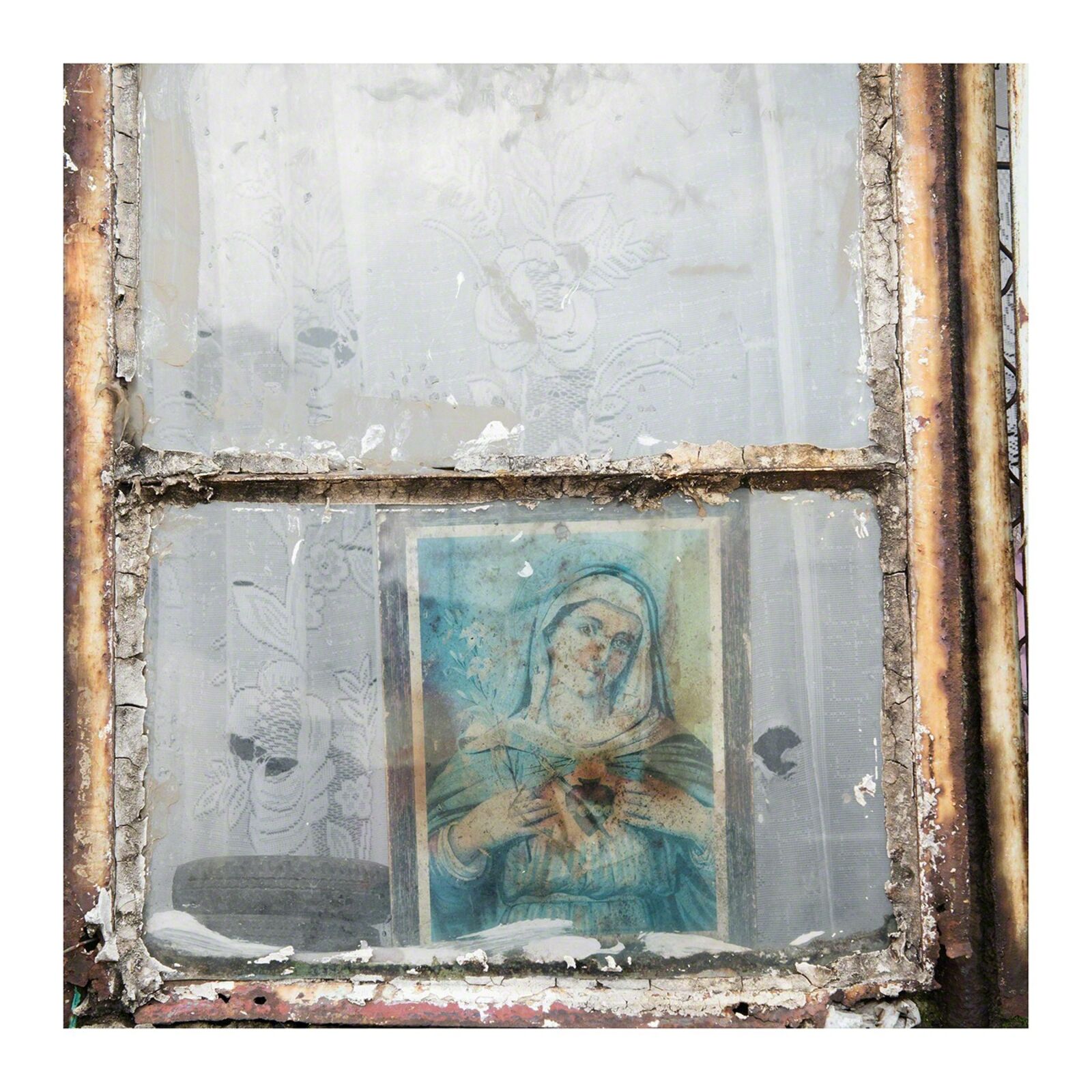 A picture of a painting of a woman in a window.