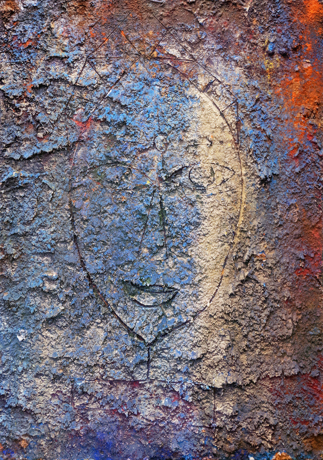 A close up of a face drawn on a wall.