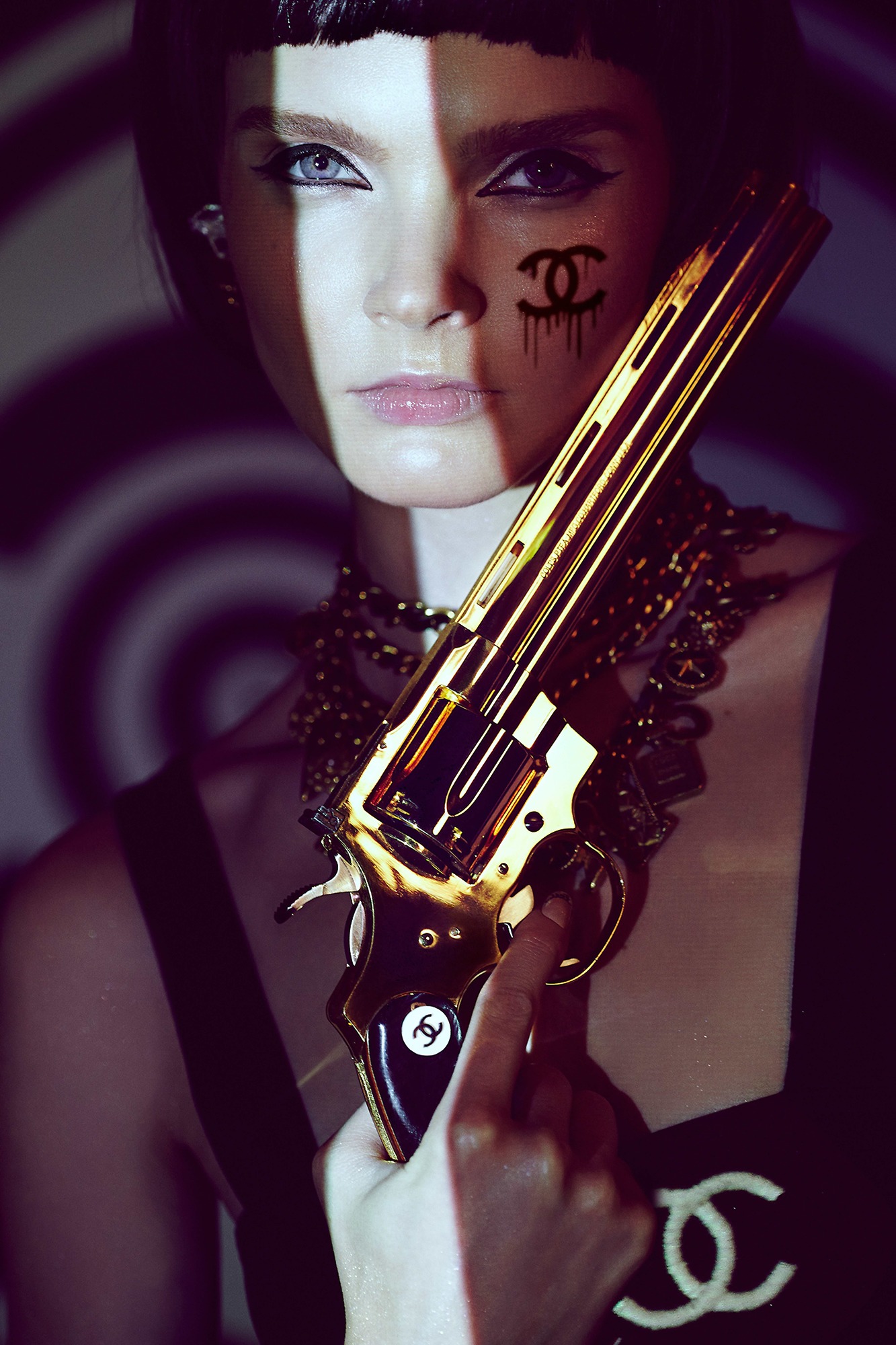 A woman holding a gun in her hand. 