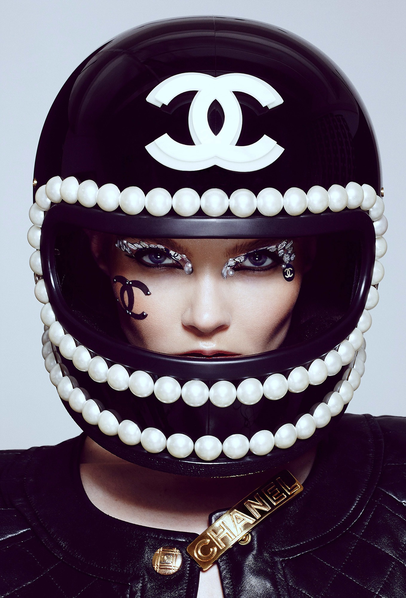 A woman wearing a helmet with pearls on it.
