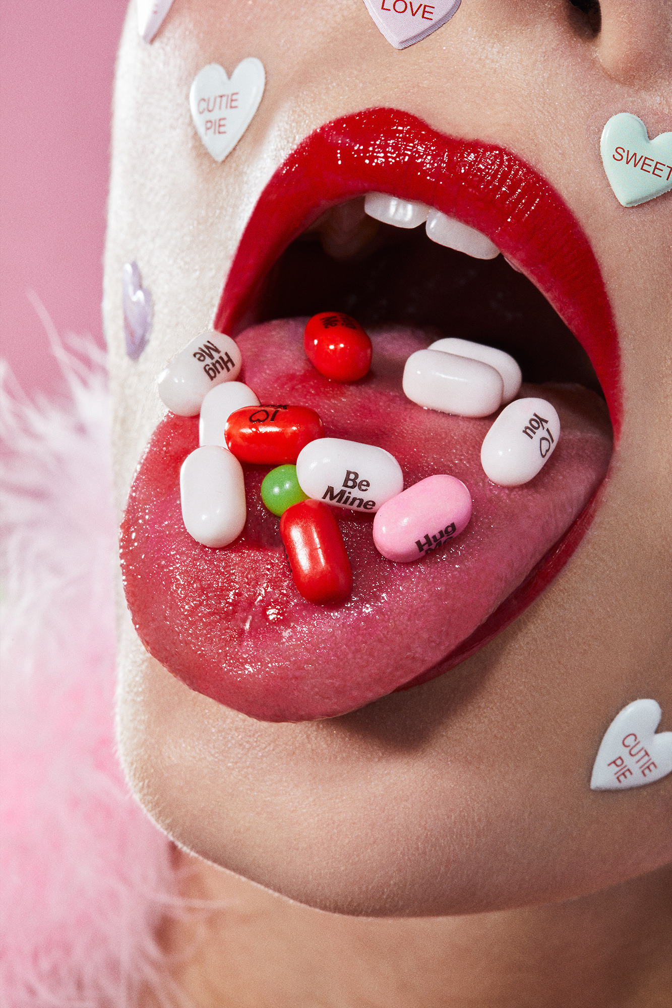 A close up of a woman's mouth covered in candy hearts.