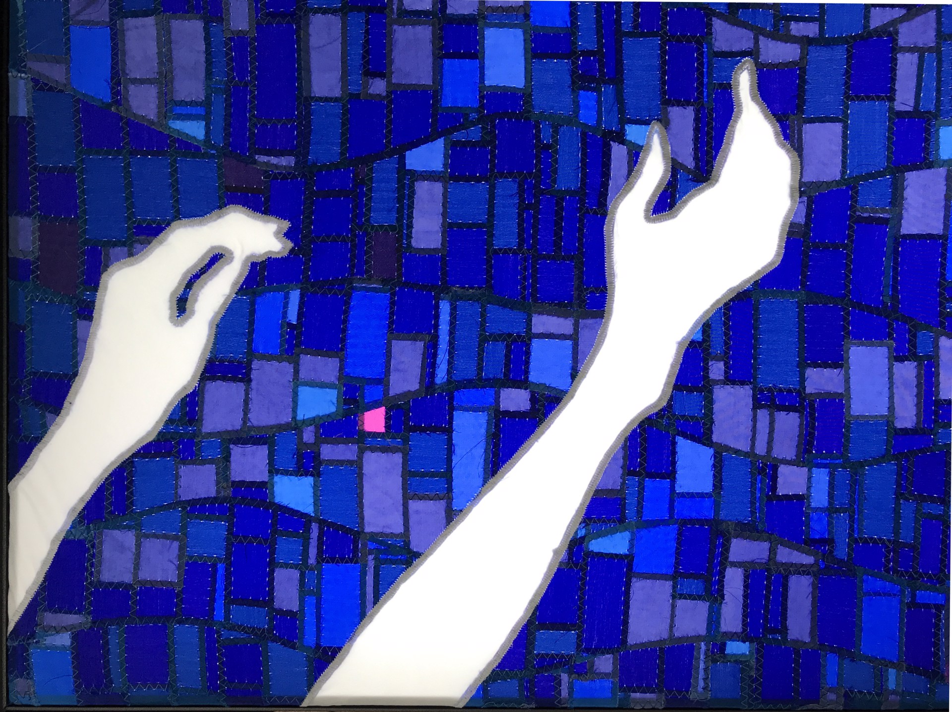 A blue mosaic tile wall with two hands reaching up to the sky.