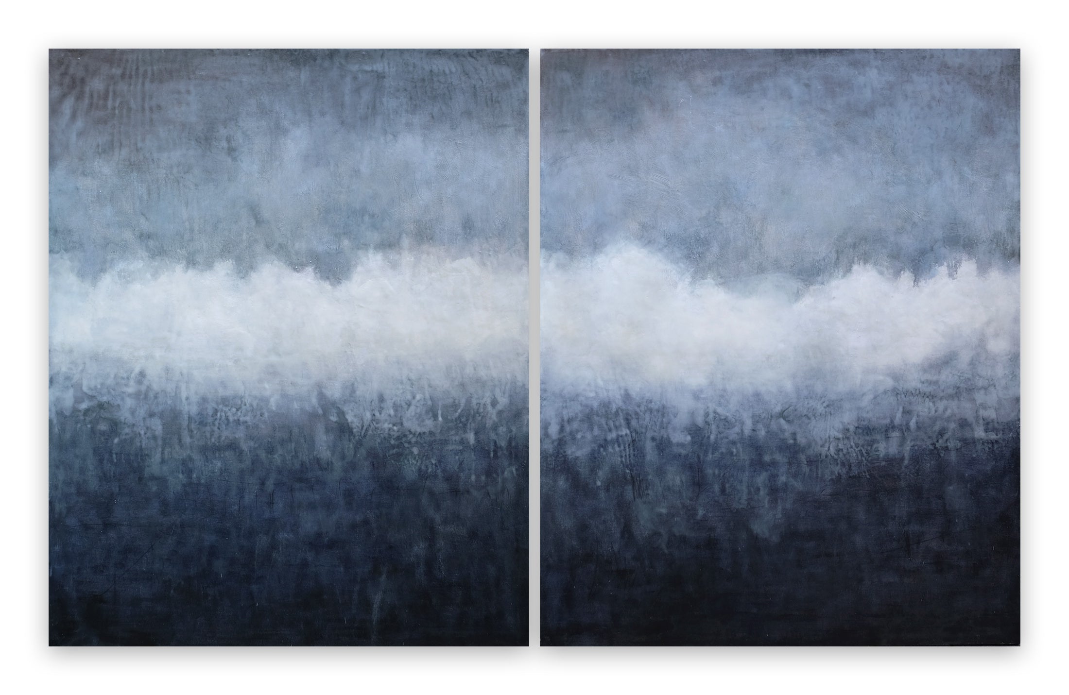 A pair of blue and white paintings on a white wall.