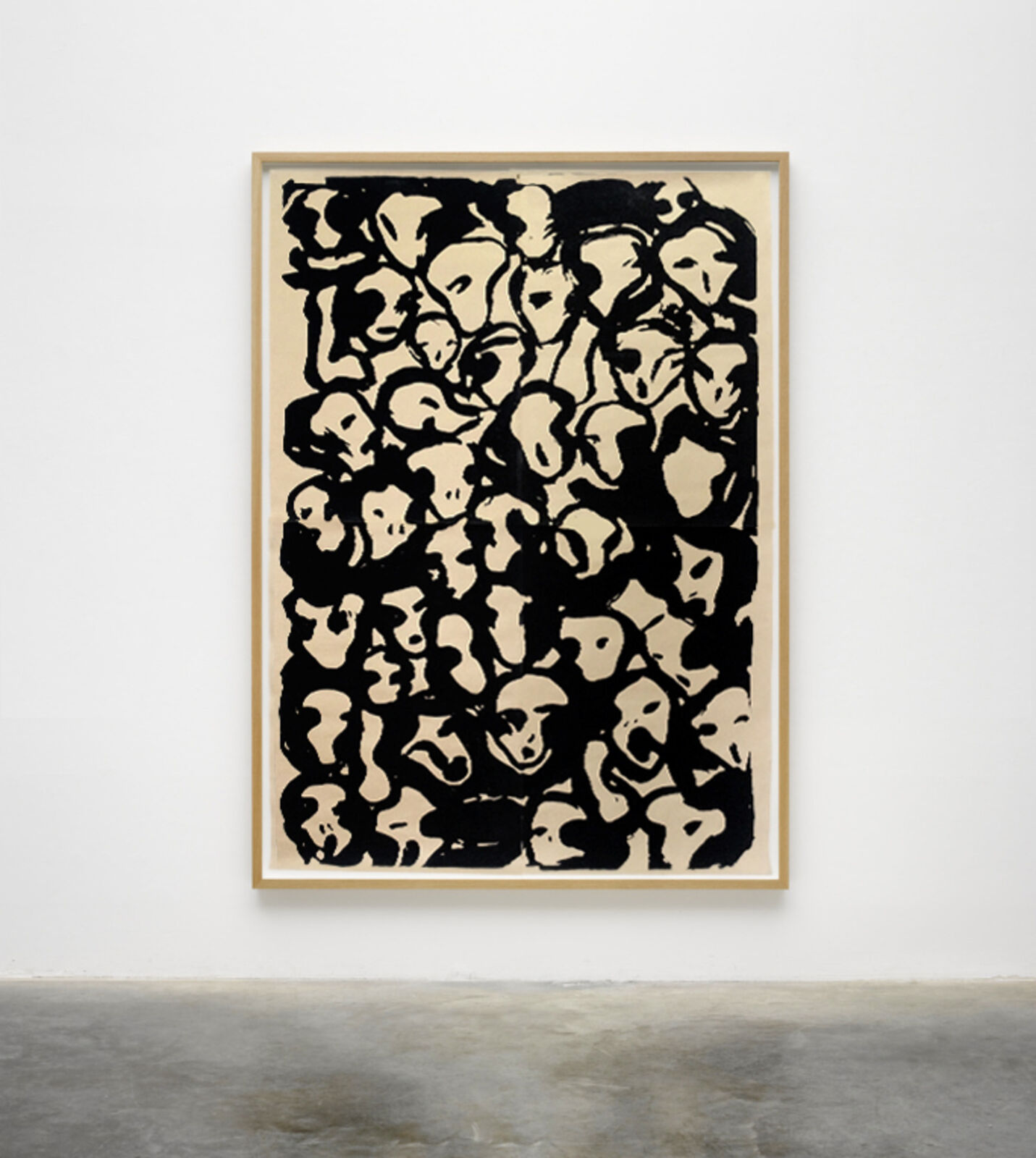 A black and white painting hanging on a wall in a room.