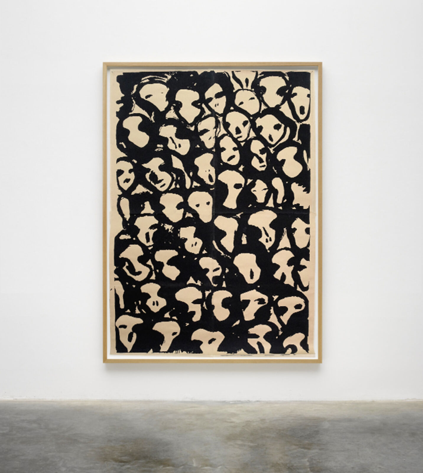 A black and white painting hanging on a wall in a room.