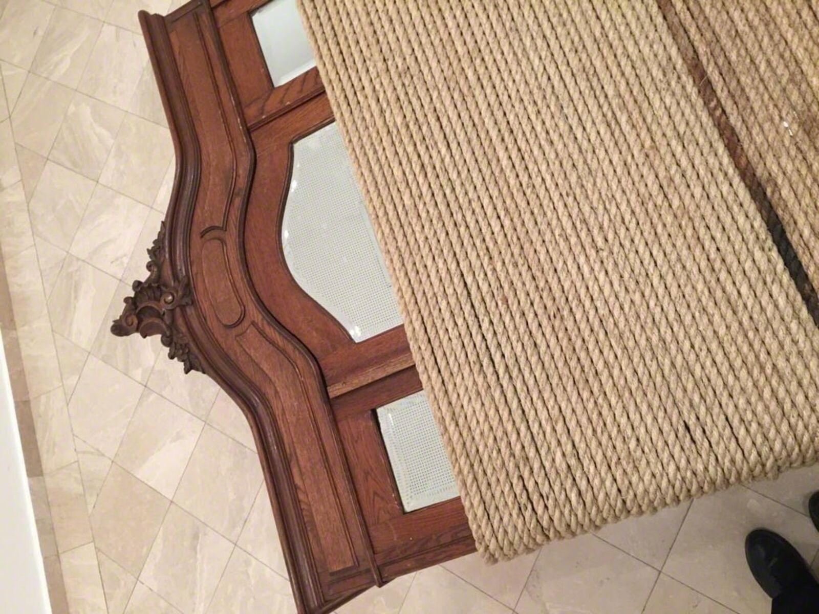 A wooden bench with a blanket on top of it.