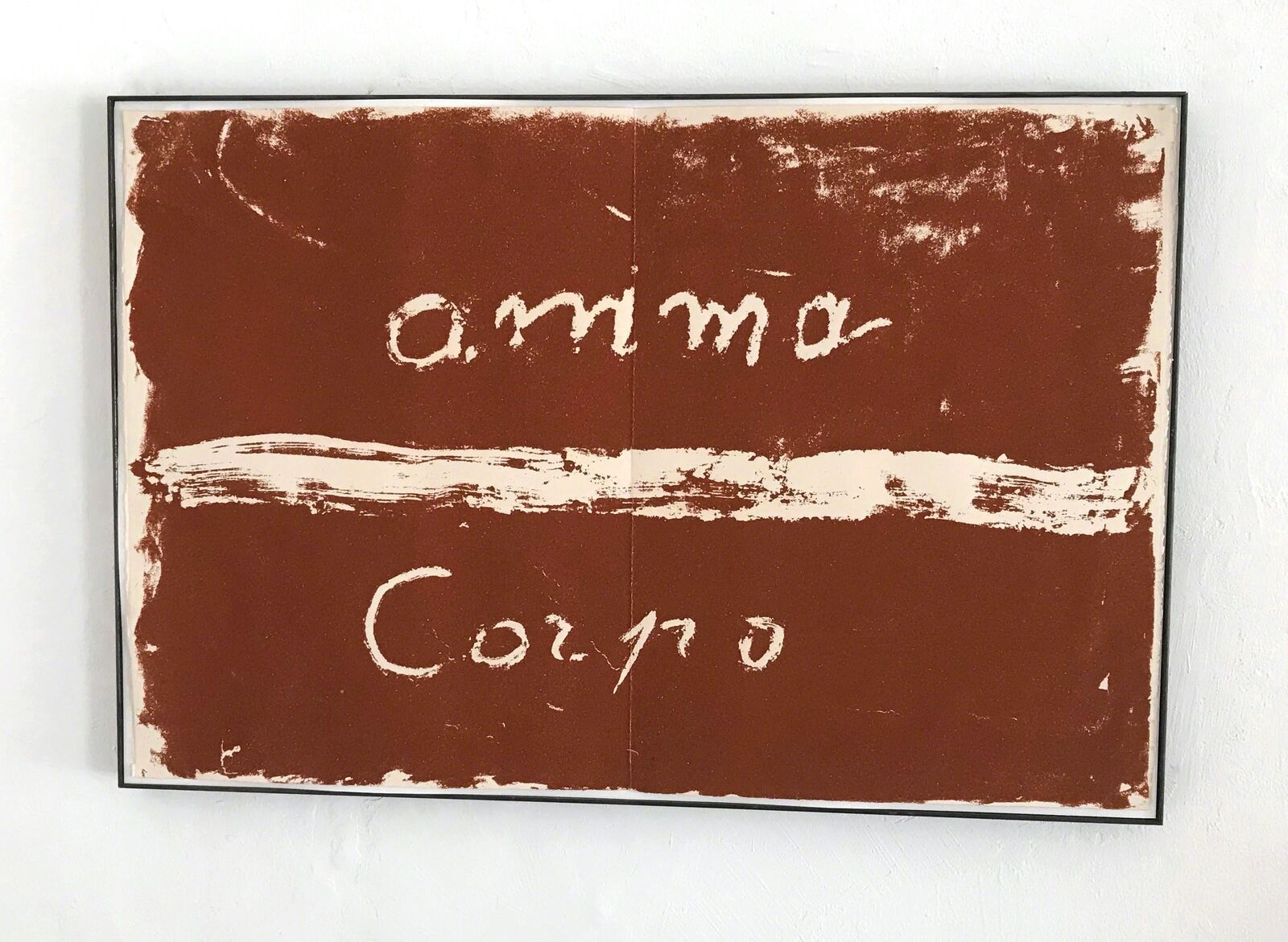 A painting on a wall with the word "amma" written on it.