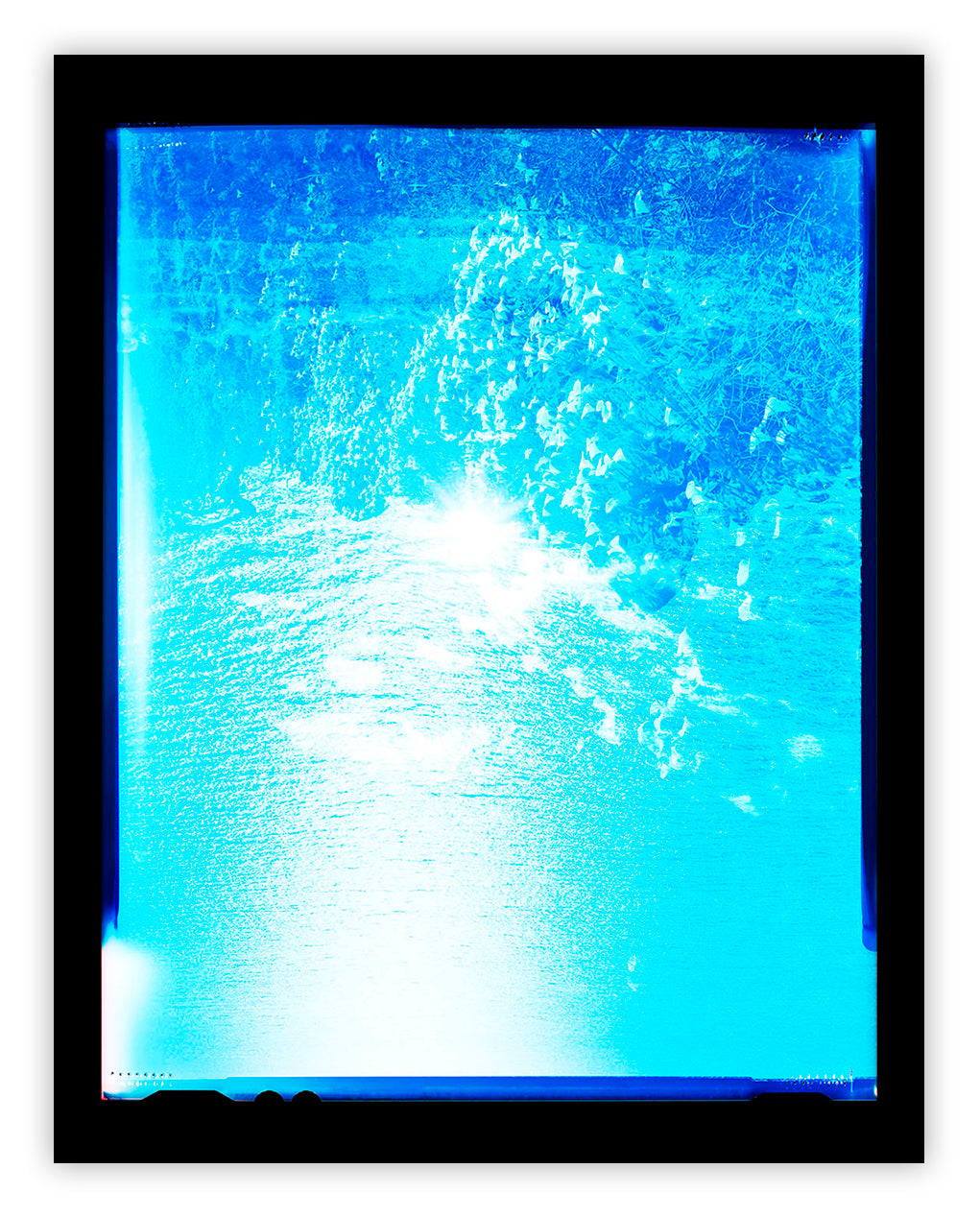 A picture of a blue ocean with a black frame.