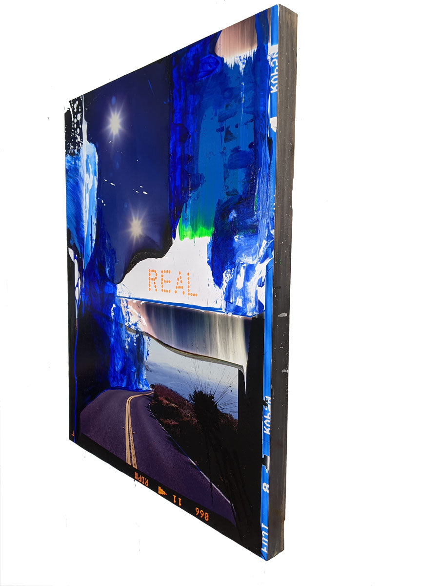 A painting of a road with the word REAL written on it.