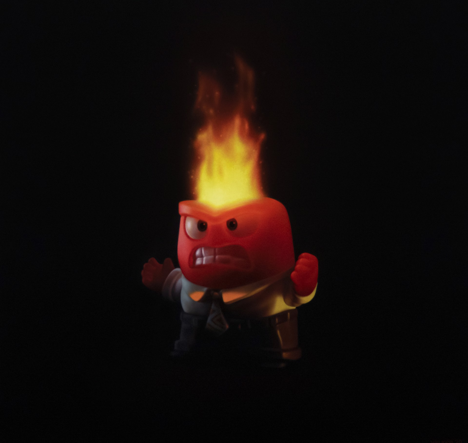 A man in a suit with a fire on his head.