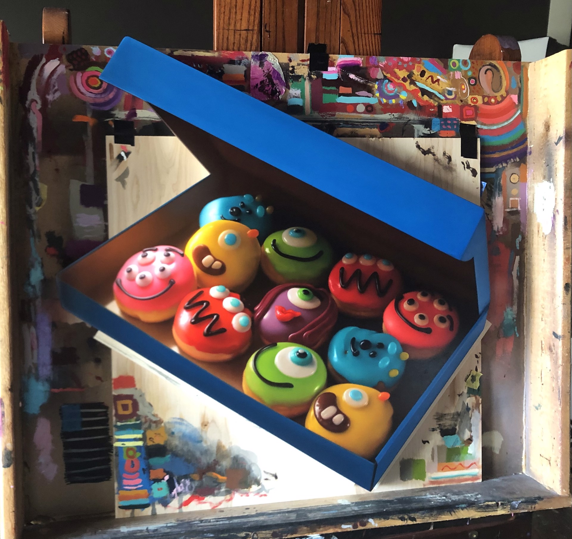 A blue box filled with lots of colorful donuts in it.