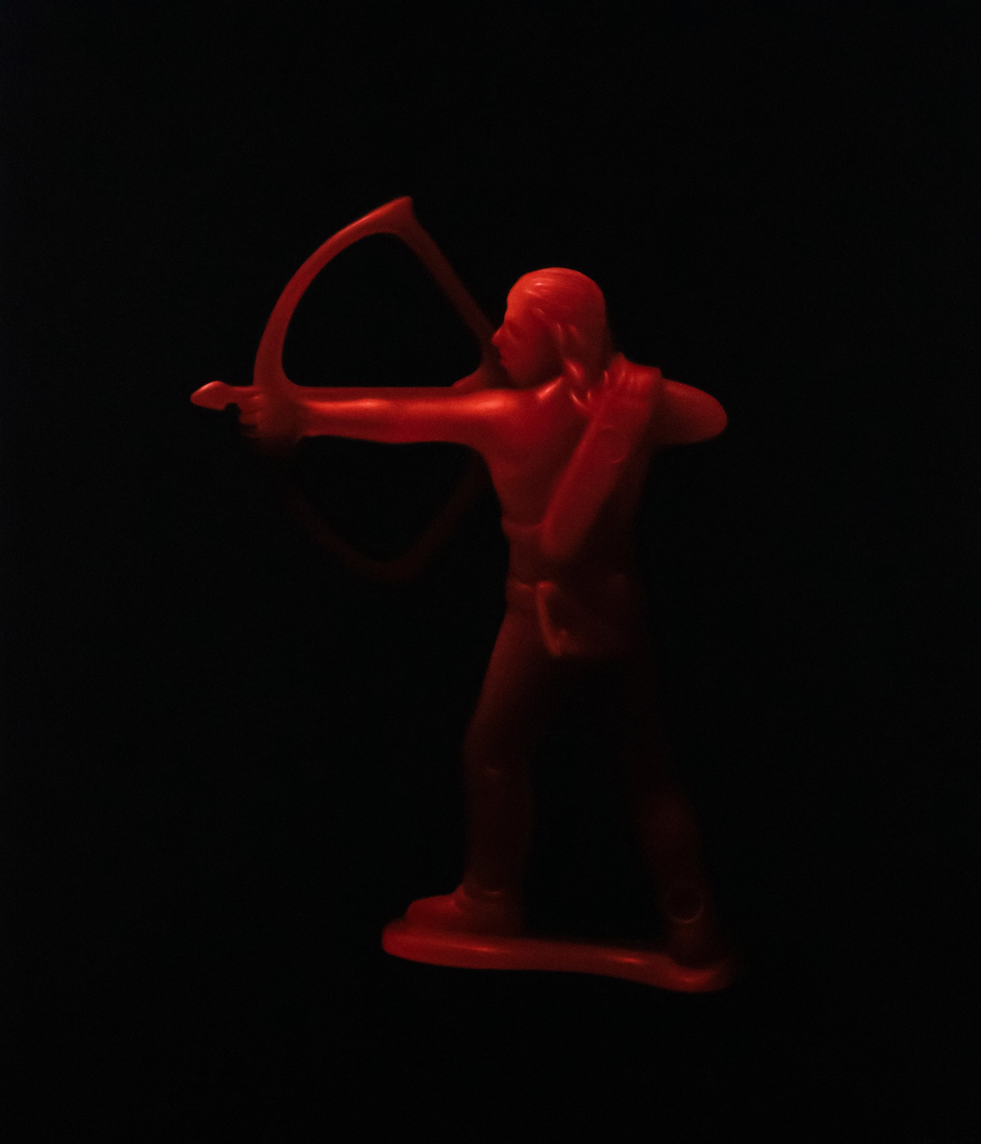 A figurine of a man holding a bow and arrow.