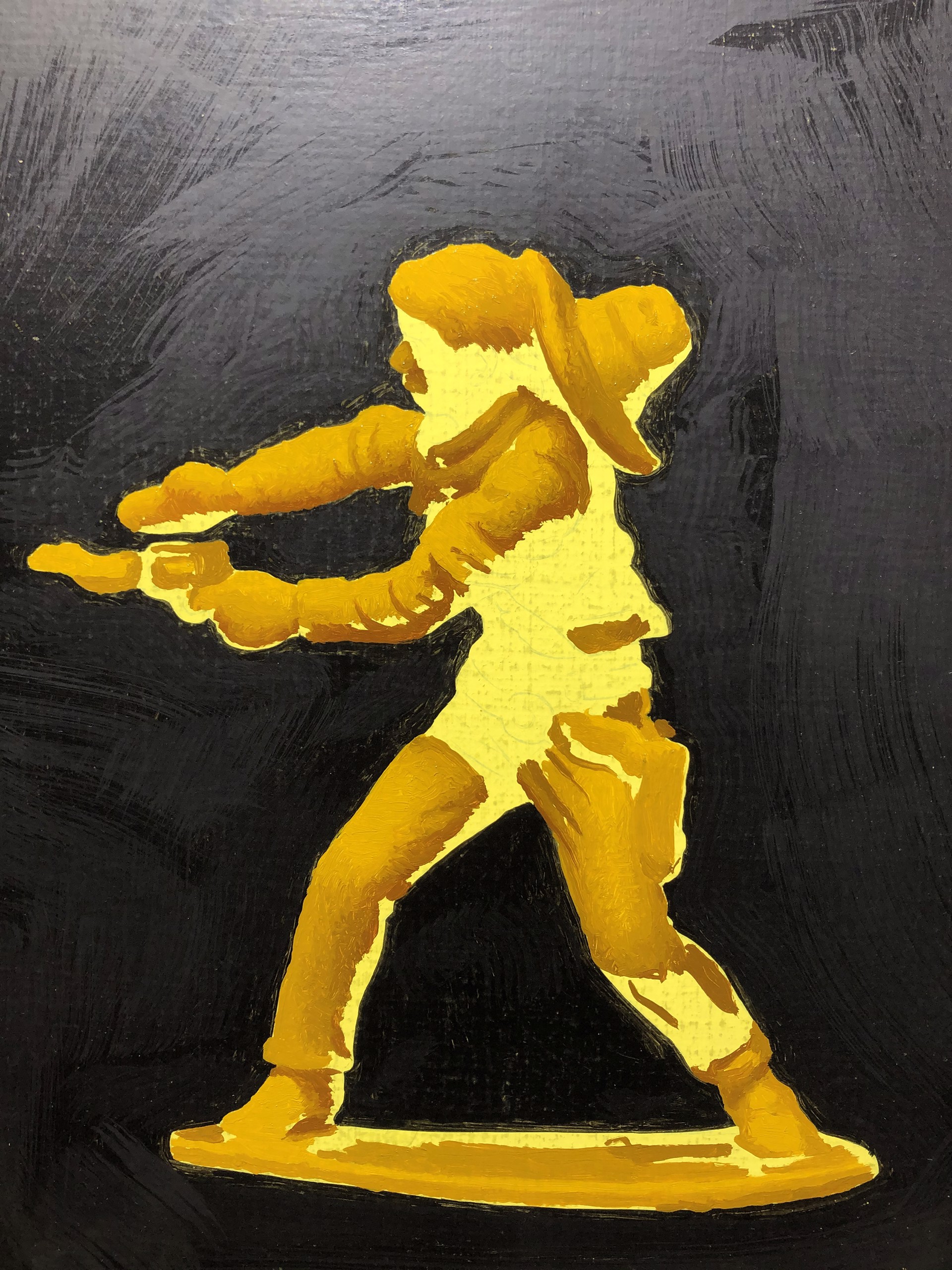 A yellow toy figure of a man holding a gun.