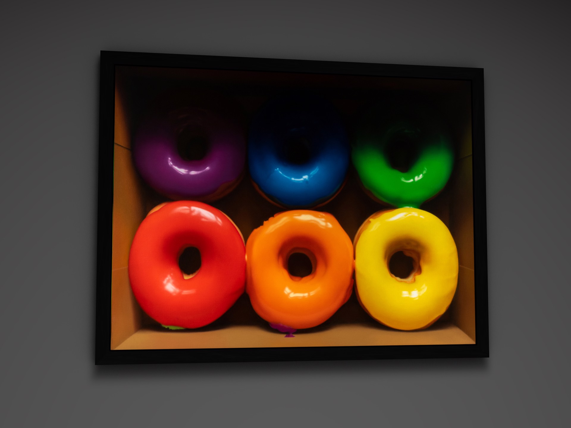 A vibrant display of six colorful glazed donuts arranged in two rows within a cardboard box.