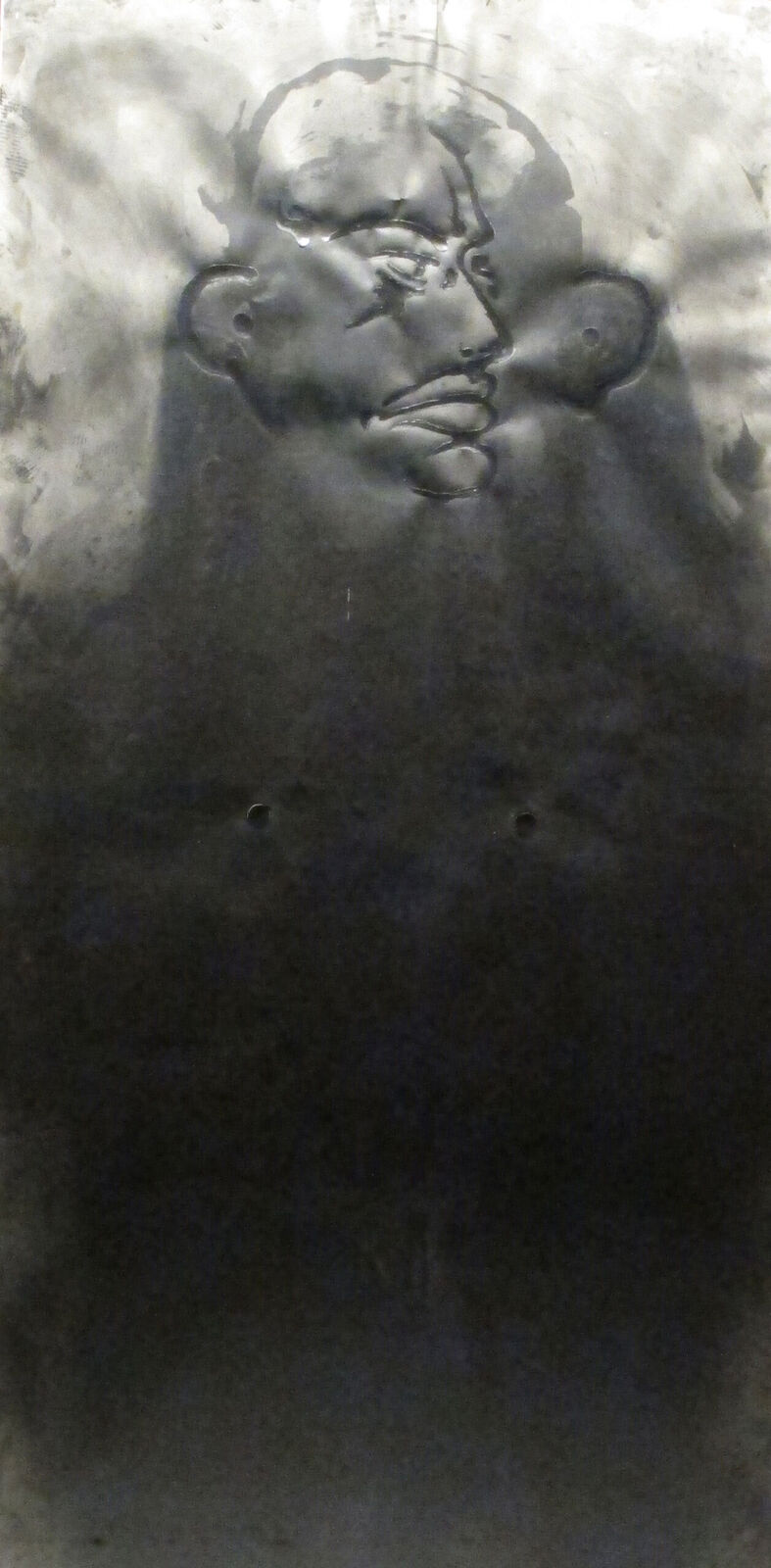 A black and white drawing of a man's face on a wall.