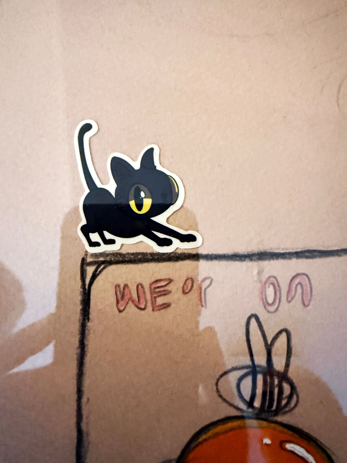 A framed drawing of a group of people in a room.