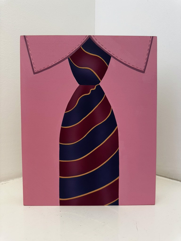 A pink card with a tie on it.