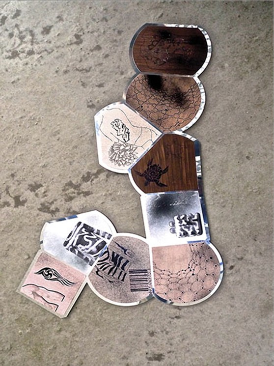 A collage of different types of stickers on a concrete surface.