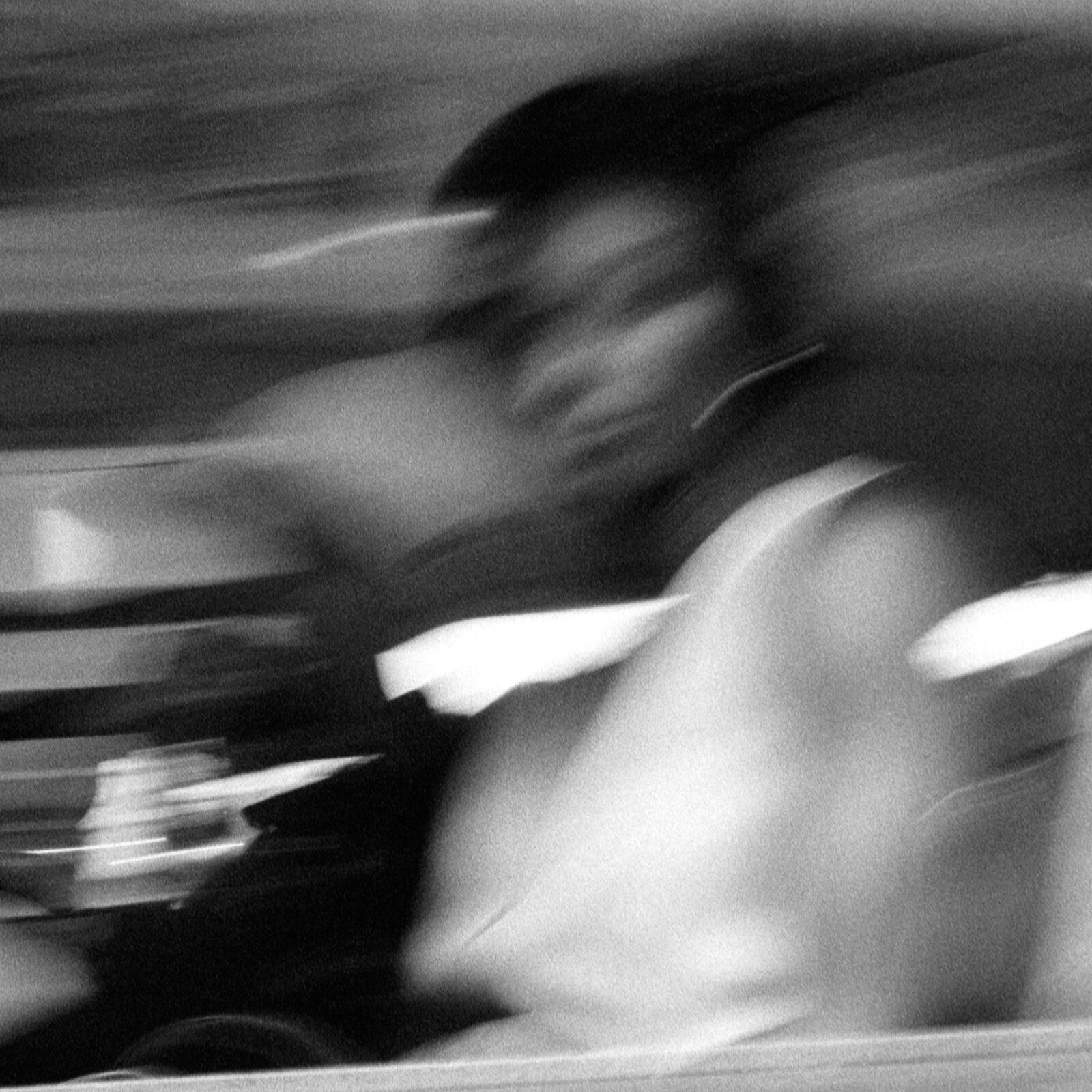 A black and white photo of people riding a bus.