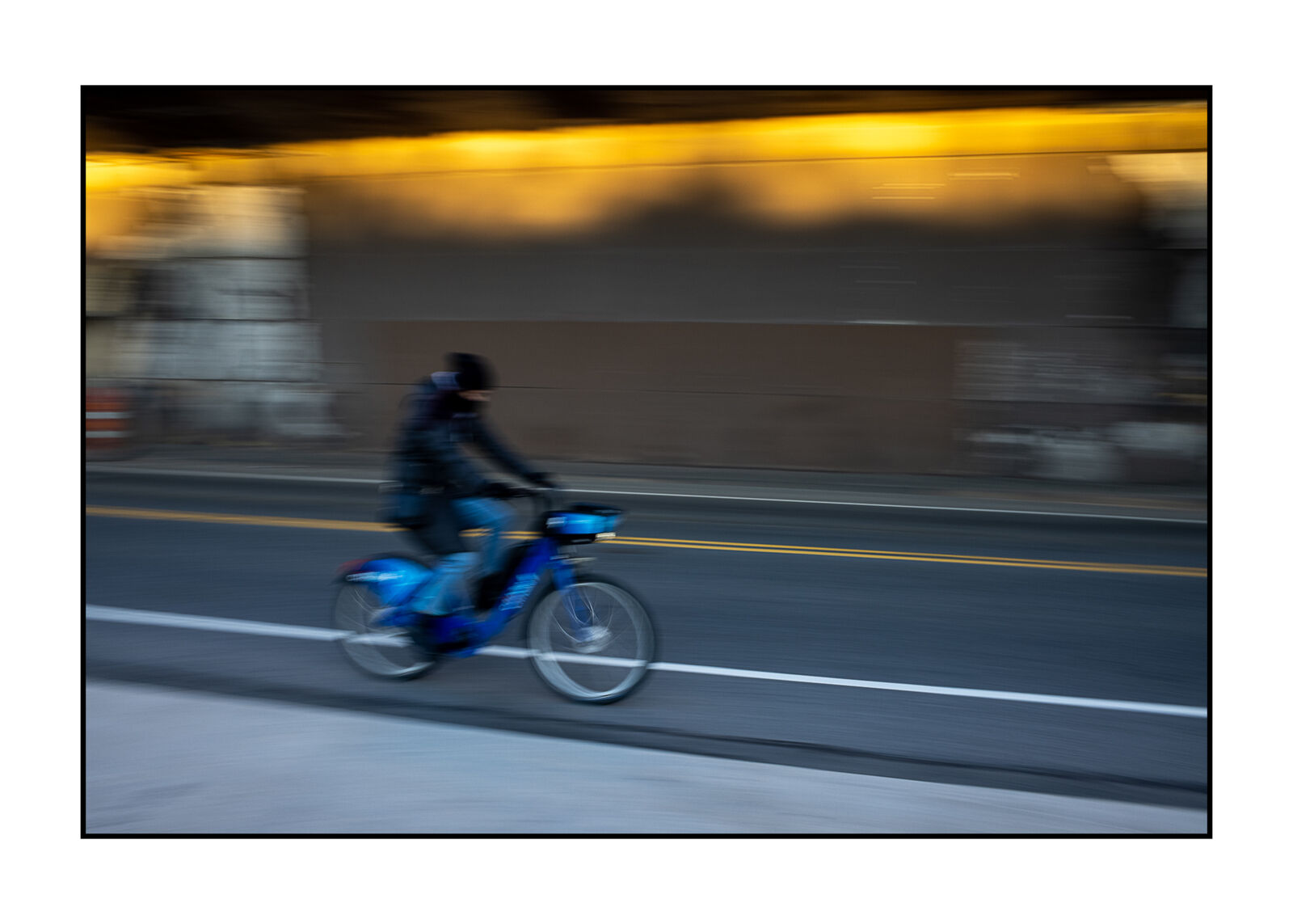 A person riding a bike on a city street.